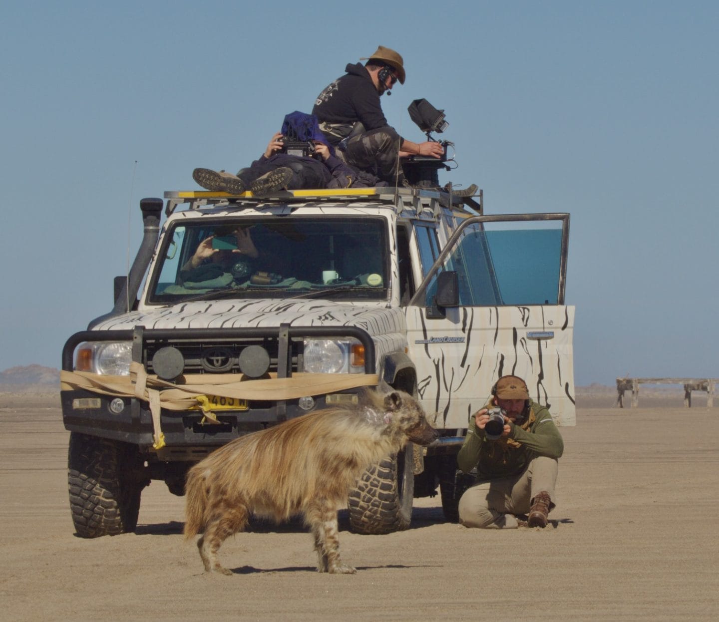 Filmmaker photographing wildlife during remote location shoot