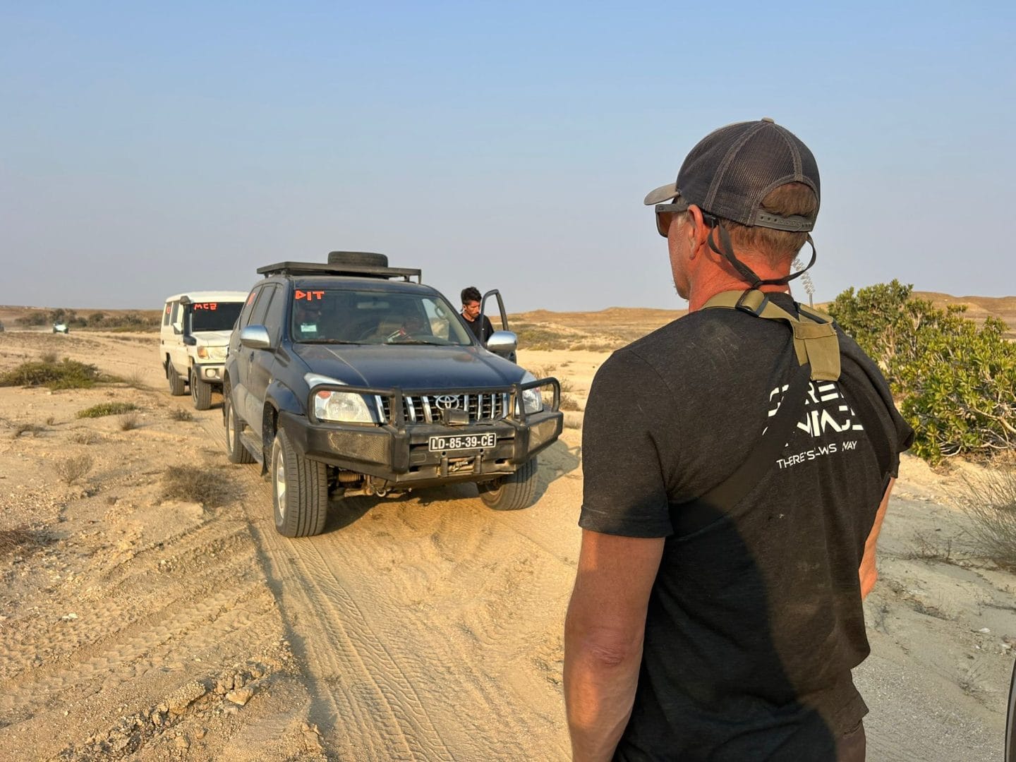 Vehicle convoy moving between filming locations on the Grand Tour Angola shoo
