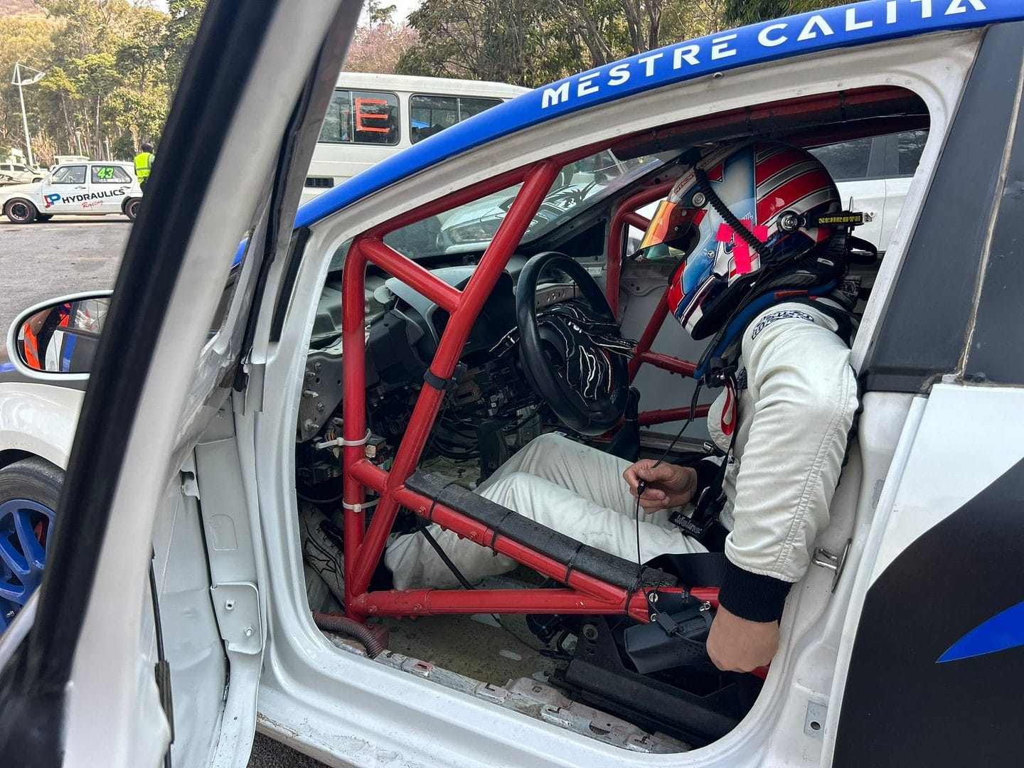 Driver in the cockpit of a race car at the Grand Tour street race in Lubango, Angola